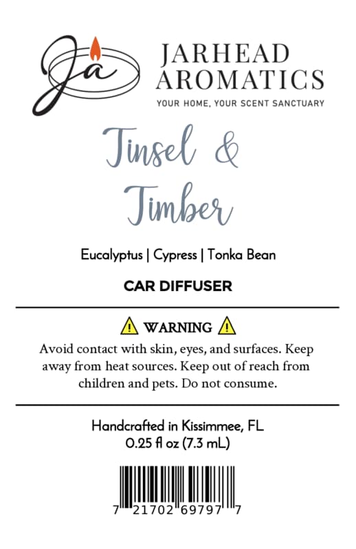 Product label for a Jarhead Aromatics Tinsel & Timber Car Diffuser, listing notes of eucalyptus, cypress, and tonka bean, alongside safety warnings, origin, volume, and a barcode.