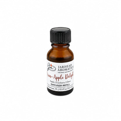 A small amber glass bottle labeled Jarhead Aromatics Cran-Apple Delight Cold Air Diffuser Refill, featuring a home fragrance oil blend of cranberry, apple, and warm cinnamon scents, set against a white background.