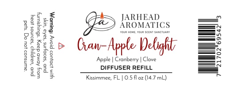 Label for Jarhead Aromatics Cran-Apple Delight Cold Air Diffuser Refill, featuring the enticing scents of cranberry, apple, and warm cinnamon; 0.5 fl oz home fragrance oil—warning: avoid contact with skin and eyes; barcode located on right side.