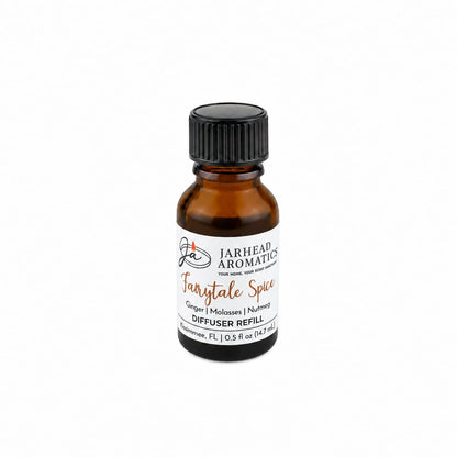 A small amber glass bottle labeled Jarhead Aromatics Fairytale Spice Cold Air Diffuser Refill features gingerbread, molasses, and warm spice scents. This holiday home fragrance is perfect for creating a cozy atmosphere and comes with a black screw cap—ideal as a cold air diffuser refill or for infusing your space with inviting gingerbread notes.