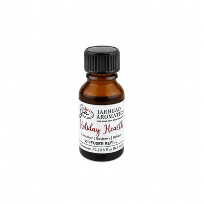 Small amber glass bottle of Holiday Hearth Cold Air Diffuser Refill | Cinnamon Clove, Bayberry & Balsam with a black cap and a white label reading Cinnamon, Bayberry, and Balsam.