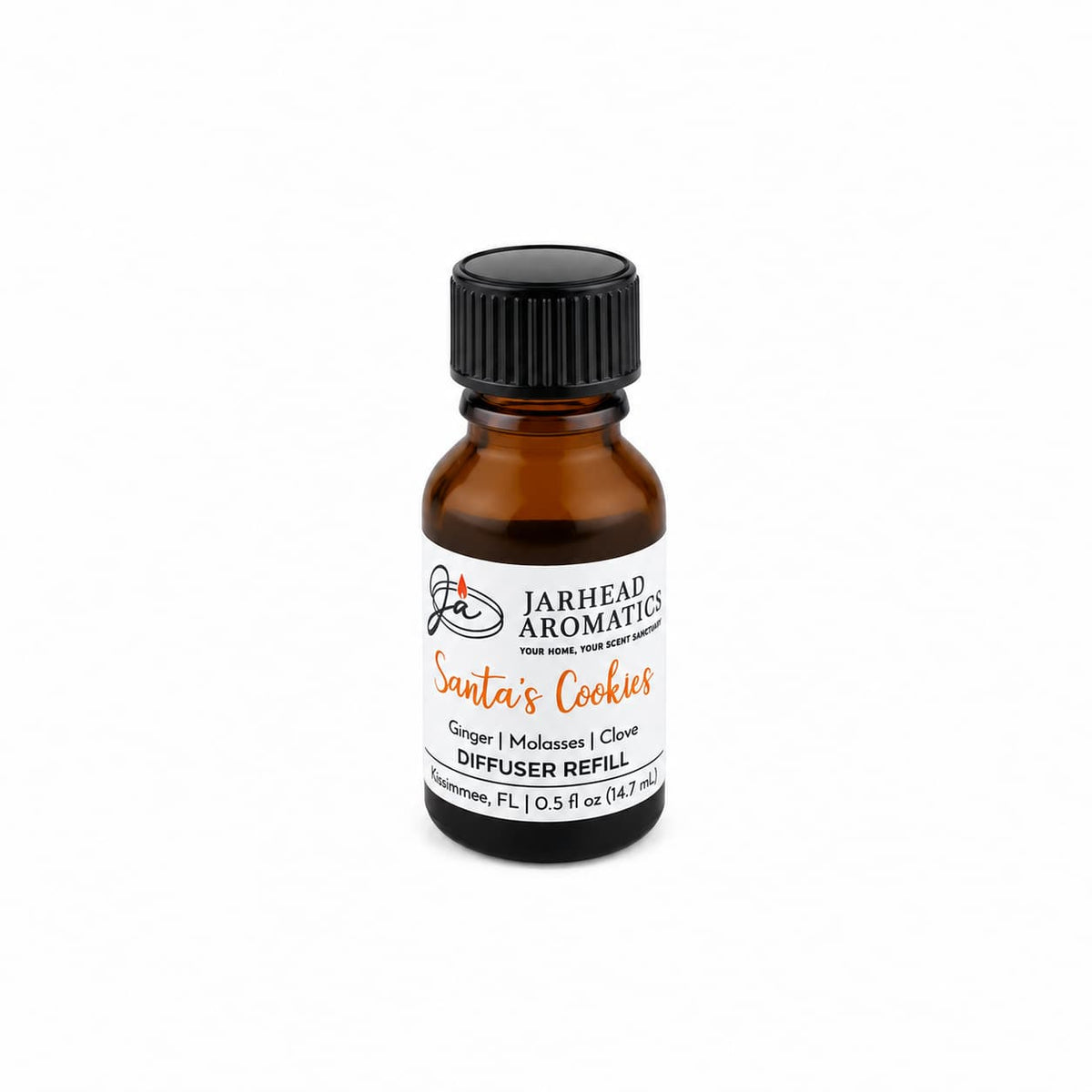 A small amber glass bottle of Santa’s Cookies Cold Air Diffuser Refill with a black cap and a white label, featuring a scent profile of ginger, molasses, and clove.