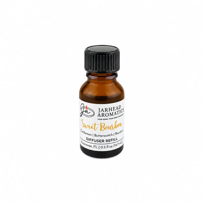 A small amber glass bottle labeled Jarhead Aromatics Sweet Bourbon Cold Air Diffuser Refill | Bourbon, Butterscotch & Brown Sugar rests on a white background—an ideal home fragrance oil featuring rich notes of bourbon, butterscotch, and brown sugar for use in your favorite cold air diffuser.