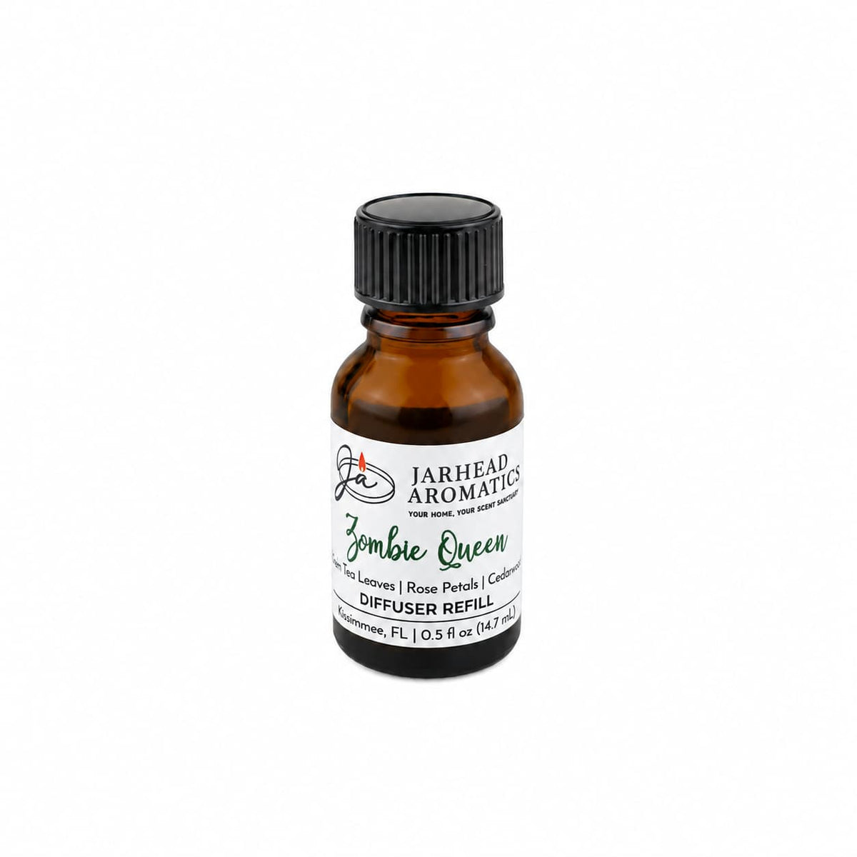 A small amber bottle labeled Jarhead Aromatics Zombie Queen Cold Air Diffuser Refill—blending black tea, rose petals, and cedarwood—rests on a white background with its black screw cap, infusing your home with an enchanting gothic aroma that adds a mysterious touch to any space.