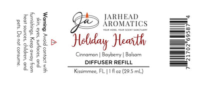 Product label for a Holiday Hearth Car Diffuser Refill | Cinnamon, Clove & Bayberry, listing safety warnings, scent notes of cinnamon, bayberry, and balsam, and a barcode for this Christmas car fragrance.
