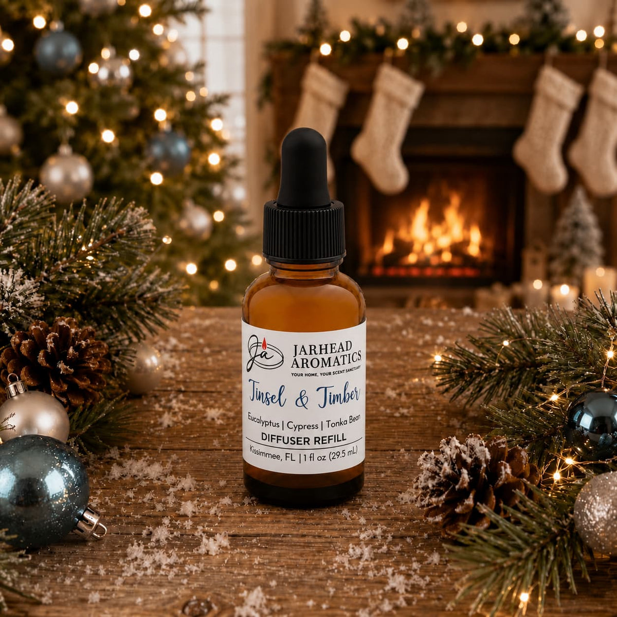 A brown glass dropper bottle of Tinsel & Timber Car Diffuser Refill sits on a wooden surface surrounded by holiday decorations, pine branches, and ornaments in front of a fireplace.