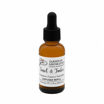 Amber glass dropper bottle of Tinsel & Timber Car Diffuser Refill, a Christmas tree fragrance with notes of eucalyptus, cypress, and tonka bean.
