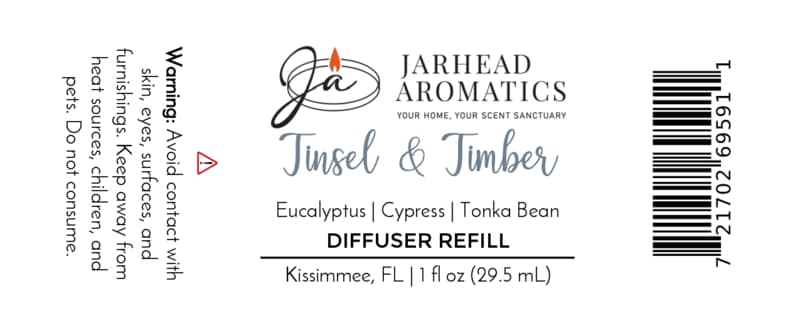 Product label for a Jarhead Aromatics Tinsel & Timber Car Diffuser Refill, listing scent notes of eucalyptus, cypress, and tonka bean, including a winter car air freshener warning to avoid contact with skin and eyes, and a barcode.
