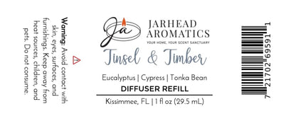 Product label for a Jarhead Aromatics Tinsel & Timber Car Diffuser Refill, listing scent notes of eucalyptus, cypress, and tonka bean, including a winter car air freshener warning to avoid contact with skin and eyes, and a barcode.