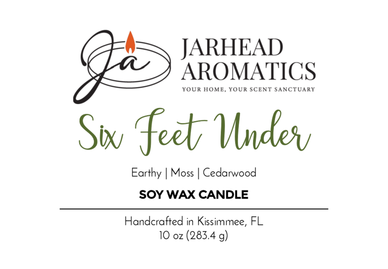 Jarhead Aromatics Six Feet Under - Soy Wax Candle, 10 oz (283.4 g), features an earthy overgrown graveyard scent with moss and cedarwood notes. Handcrafted in Kissimmee, FL. Label shows a candle flame logo.