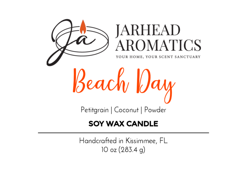 A “Jarhead Aromatics” label for the “Beach Day - Soy Wax Candle” features orange script, scent notes of petitgrain, coconut, powder—a summer beach fragrance with essential oils. Text: “Handcrafted in Kissimmee, FL, 10 oz (283.4 g)”.