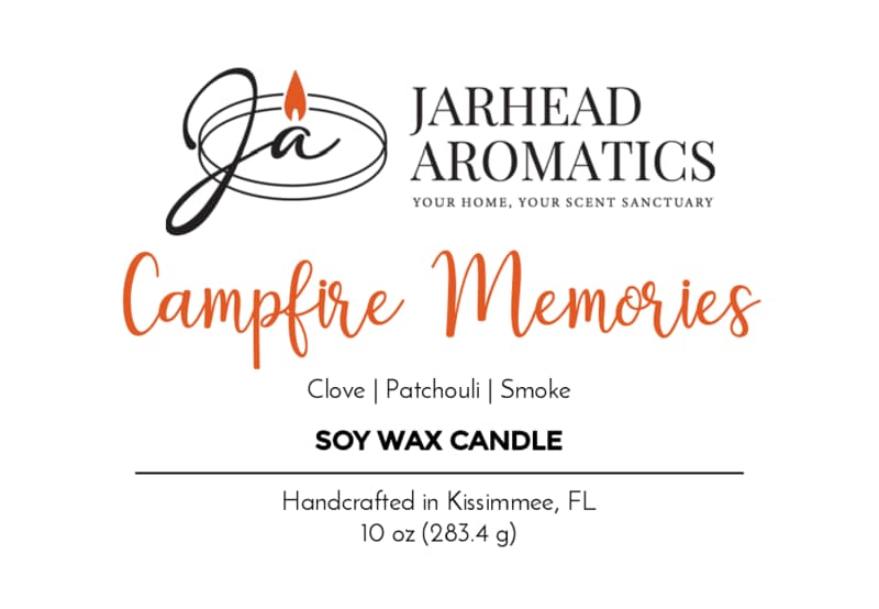 Candle label reads: Campfire Memories Soy Wax Candle by Jarhead Aromatics. Fragrance notes of smoky embers, maple, moss, and patchouli evoke a cozy autumn atmosphere. This 10 oz soy candle is handcrafted in Kissimmee, FL. The logo features a stylized "JA" with a flame.