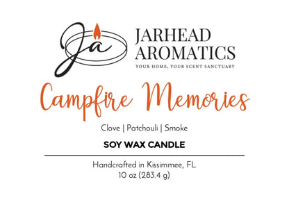 Candle label reads: Campfire Memories Soy Wax Candle by Jarhead Aromatics. Fragrance notes of smoky embers, maple, moss, and patchouli evoke a cozy autumn atmosphere. This 10 oz soy candle is handcrafted in Kissimmee, FL. The logo features a stylized "JA" with a flame.