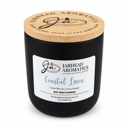 A matte black Jarhead Aromatics Coastal Linen Soy Wax Candle | Cotton Blossom, Linen & Powder featuring a light wood lid and a white label.