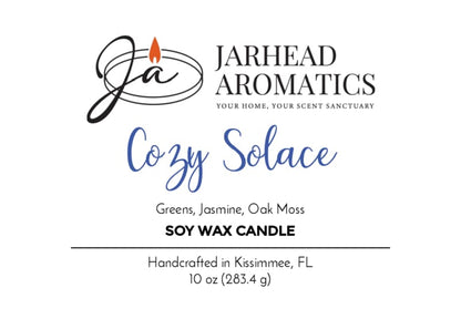 A Jarhead Aromatics hand-poured soy wax candle label for Cozy Solace, blending fresh greens, jasmine, oak moss, and musk in a comforting fall fragrance. This 10 oz (283.4 g) candle is handcrafted in Kissimmee, FL.