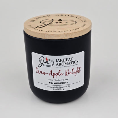 Encased in a sleek black jar with a wooden lid, the Jarhead Aromatics Cran-Apple Delight Soy Wax Candle fills your space with an inviting blend of cranberry, apple, and cinnamon. Handcrafted in Kissimmee, FL, this 10 oz (283.4 g) soy wax candle offers long-lasting fragrance and artisanal quality.