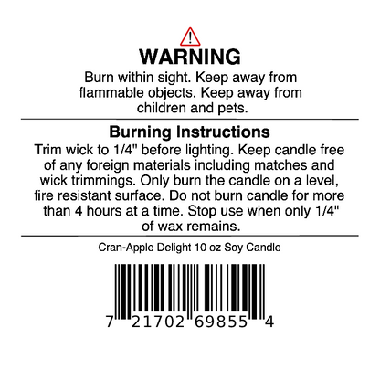 Jarhead Aromatics Cran-Apple Delight Soy Wax Candle features a candle warning label with safety instructions, burning directions, and a barcode. The label includes cautions about fire hazards, trimming the wick before each use, and keeping the candle away from children, pets, and flammable objects. This scented soy wax candle blends cranberry, apple, and cinnamon fragrances.