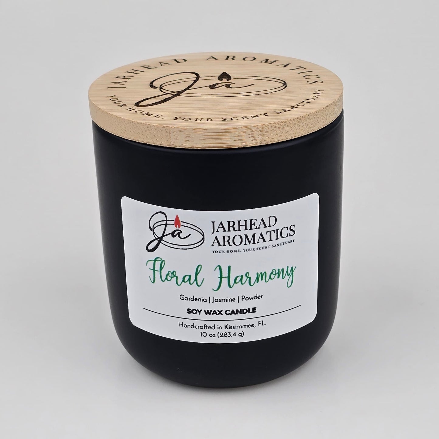 The Jarhead Aromatics Floral Harmony Soy Wax Candle comes in a sleek black jar with a wooden lid and is hand-poured in Kissimmee, FL. This 10 oz candle features an elegant blend of gardenia, jasmine, and tuberose for a long-lasting floral fragrance.