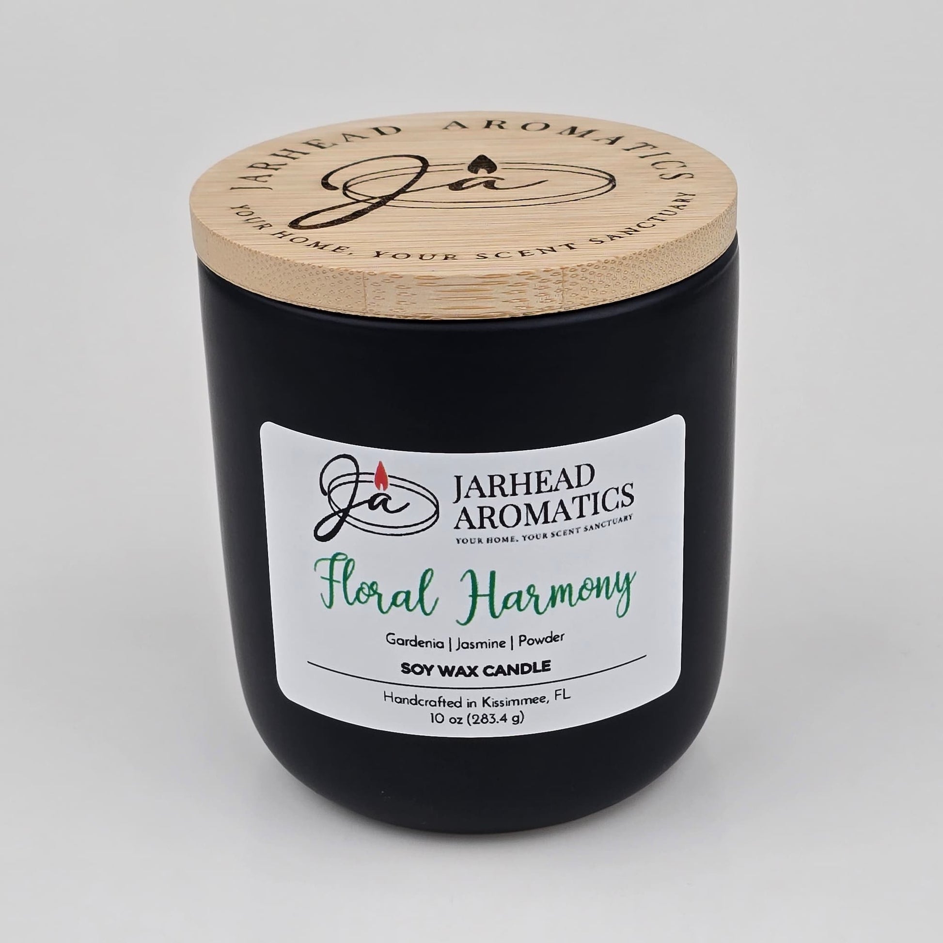 The Jarhead Aromatics Floral Harmony Soy Wax Candle comes in a sleek black jar with a wooden lid and is hand-poured in Kissimmee, FL. This 10 oz candle features an elegant blend of gardenia, jasmine, and tuberose for a long-lasting floral fragrance.