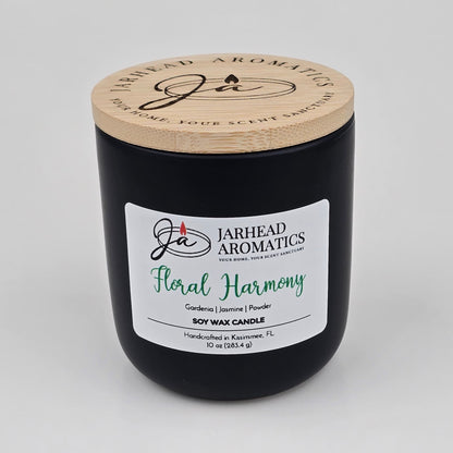 The Jarhead Aromatics Floral Harmony Soy Wax Candle comes in a sleek black jar with a wooden lid and is hand-poured in Kissimmee, FL. This 10 oz candle features an elegant blend of gardenia, jasmine, and tuberose for a long-lasting floral fragrance.