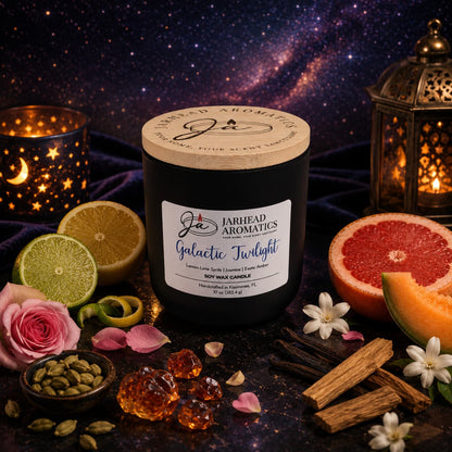 A Galactic Twilight Soy Wax Candle by Jarhead Aromatics rests on dark cloth amid citrus, jasmine, and amber notes as lanterns glow softly and a starry backdrop lends this scented candle scene a mystical ambiance.