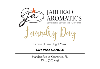 Jarhead Aromatics Laundry Day Soy Wax Candle, 10 oz (283.4g), features notes of lemon, linen, and oceanic accords. Handcrafted in Kissimmee, FL. Logo includes a flame.