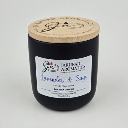The Jarhead Aromatics Lavender & Sage Soy Wax Candle features calming notes of lavender, sage, and sandalwood. Hand-poured in Kissimmee, FL, this 10 oz candle comes in a black jar with a wooden lid—perfect for a soothing ambiance.