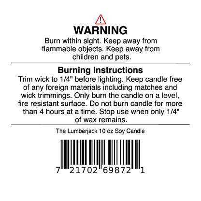 A warning label for Jarhead Aromatics' The Lumberjack Soy Wax Candle (Cedar, Oak & Mahogany) with burn instructions, safety tips, and a barcode. Directions stress wick trimming, burning on a safe surface, and supervision.