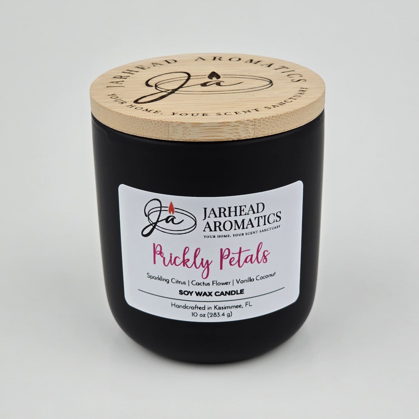 The Prickly Petals Soy Wax Candle by Jarhead Aromatics features cactus flower and citrus scents in a sleek black jar with a wooden lid—hand-poured in Kissimmee, FL for your perfect cactus flower candle experience.