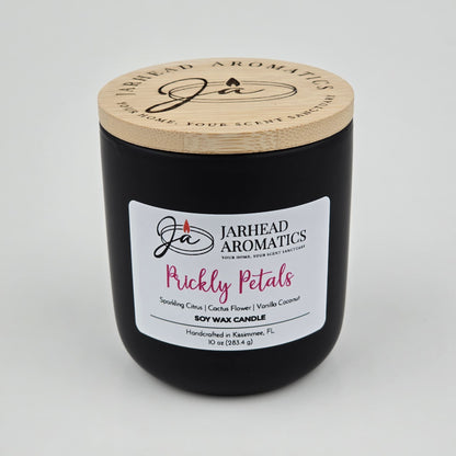 The Prickly Petals Soy Wax Candle by Jarhead Aromatics features cactus flower and citrus scents in a sleek black jar with a wooden lid—hand-poured in Kissimmee, FL for your perfect cactus flower candle experience.