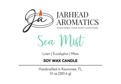 Jarhead Aromatics Sea Mist Soy Wax Candle label: Clean Coastal Linen & Sea Salt scent with linen, eucalyptus, and moss notes, handcrafted in Kissimmee, FL. Features a flame logo. Net weight: 10 oz (283.4 g).