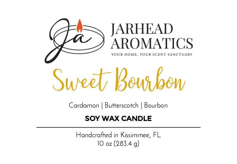 The Jarhead Aromatics Sweet Bourbon Soy Wax Candle | Warm Bourbon, Brown Sugar & Oak Candle features a label with a cursive logo and lists scent notes of warm bourbon, brown sugar, and oak. This 10 oz hand-poured soy candle is handcrafted in Kissimmee, FL and delivers a long-lasting fragrance.