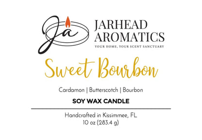 The Jarhead Aromatics Sweet Bourbon Soy Wax Candle | Warm Bourbon, Brown Sugar & Oak Candle features a label with a cursive logo and lists scent notes of warm bourbon, brown sugar, and oak. This 10 oz hand-poured soy candle is handcrafted in Kissimmee, FL and delivers a long-lasting fragrance.
