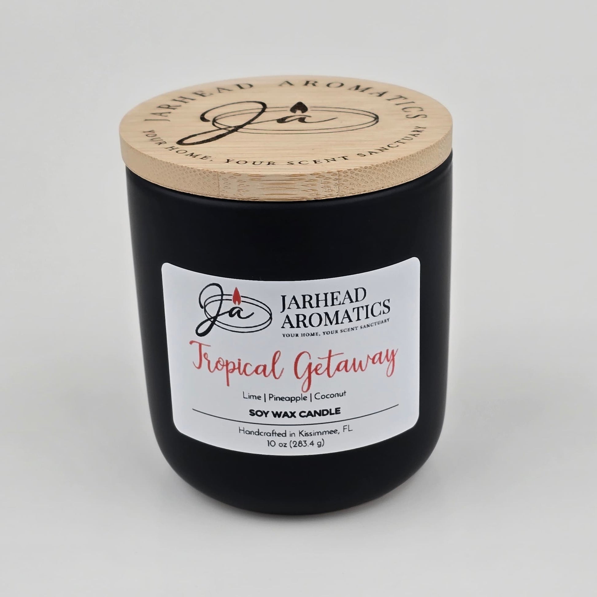 The Jarhead Aromatics Tropical Getaway Soy Wax Candle blends mango, coconut, and pineapple scents for an island-inspired escape. This hand-poured candle comes in a sleek black jar with a wooden lid, crafted in Kissimmee, FL.
