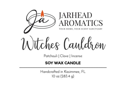 The Jarhead Aromatics candle label reads: Witches Cauldron Soy Wax Candle | Orange Blossom, Patchouli, Clove & Incense Halloween Candle, 10 oz, handcrafted in Kissimmee, FL. The logo displays a stylized JA with an orange flame.
