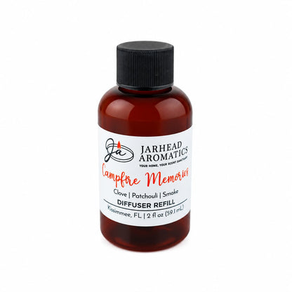 A brown bottle labeled Jarhead Aromatics Campfire Memories Diffuser Refill | Maple, Clove & Smoky Embers delivers an inviting autumn scent featuring notes of clove, maple, and smoky embers. Perfect for enhancing your home fragrance collection, the bottle contains 2 fl oz (59.1 mL) and is topped with a black screw cap.
