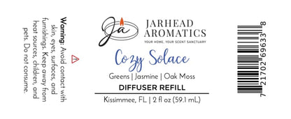 Jarhead Aromatics Cozy Solace Diffuser Refill | Fresh Greens, Jasmine, Oak Moss label includes a usage warning, ingredient notes (fresh greens, jasmine, oak moss), company logo, barcode, and bottle size (2 fl oz / 59.1 mL). Crafted in Kissimmee, FL, this autumn home fragrance is perfect for your favorite home fragrance diffuser.
