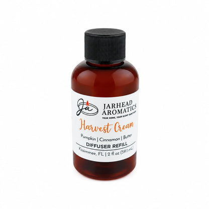 A brown bottle labeled Jarhead Aromatics Harvest Cream Diffuser Refill with a black cap stands against a plain white background, offering an inviting blend of pumpkin spice, brown sugar, and vanilla cream—perfect as an autumn home fragrance.