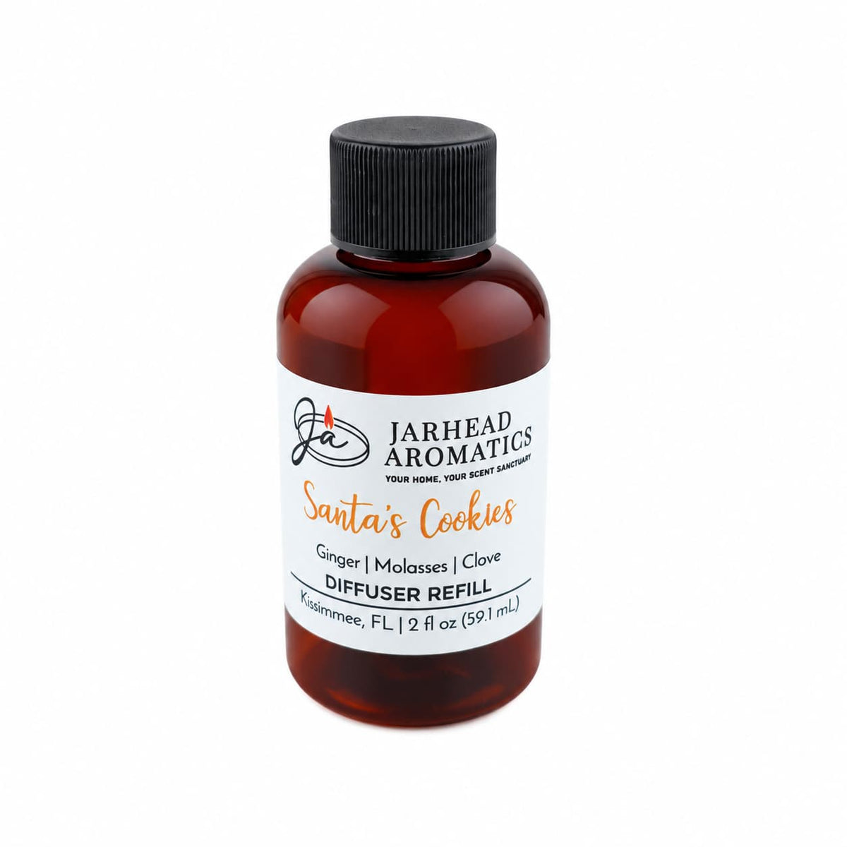A small amber glass bottle of Jarhead Aromatics Santa’s Cookies Diffuser Refill with a black cap and a label detailing the scent notes of ginger, brown sugar, molasses, and vanilla.