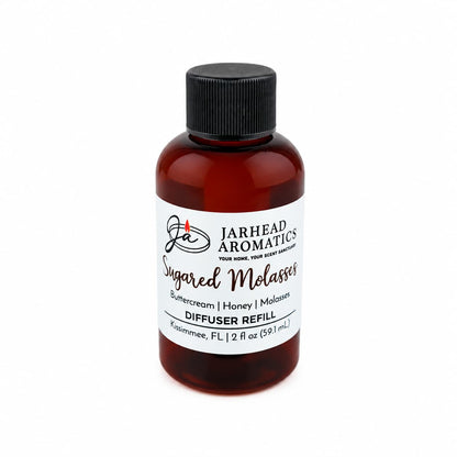 A brown bottle labeled Jarhead Aromatics Sugared Molasses Diffuser Refill | Buttercream, Honey & Dark Molasses features cozy notes of buttercream, honey, and dark molasses. Ideal for bringing an autumnal ambiance to your space, this home fragrance comes in a 2 fl oz (59.1 mL) bottle with a black cap.