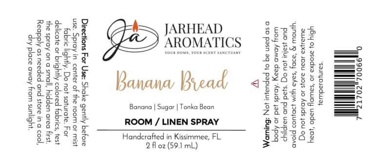A Jarhead Aromatics Banana Bread Room & Linen Spray label for the Banana, Walnut & Warm Vanilla scent, featuring a gourmand fragrance blend with notes of banana, walnut, and warm vanilla. The label showcases directions, ingredients, warnings, and distinctive branding elements such as a flame logo—perfect for enhancing your home fragrance experience.