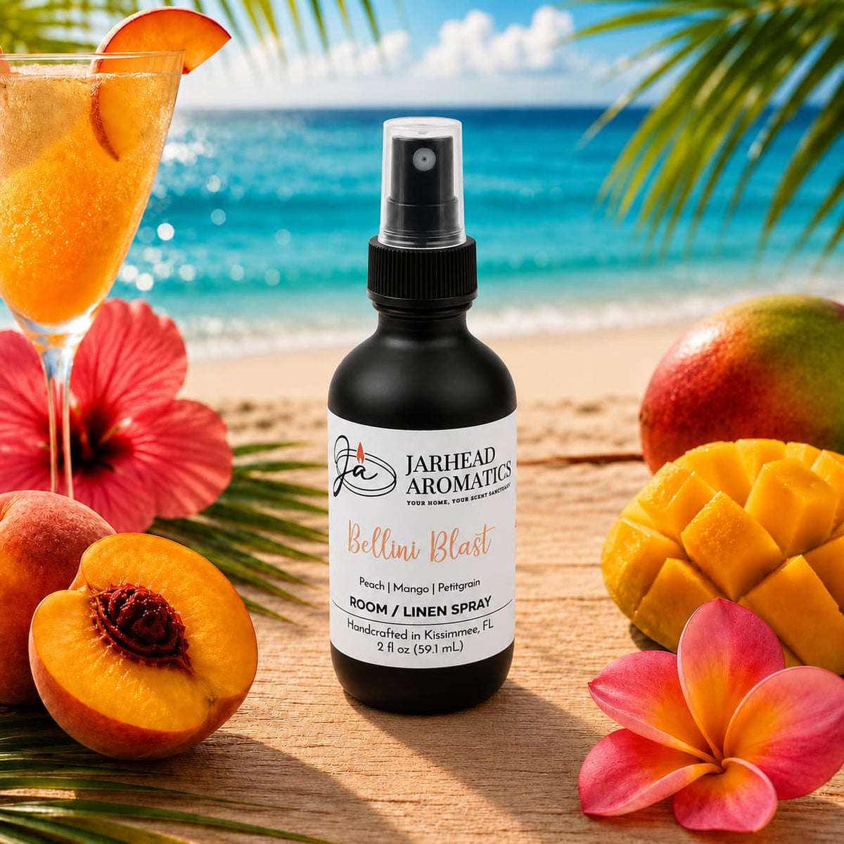 A bottle of Bellini Blast Room & Linen Spray by Jarhead Aromatics is surrounded by peaches, mangoes, tangerines, a vibrant cocktail, and lush tropical flowers on a sandy beach with the ocean and palm leaves in the background, perfectly capturing the essence of this peach, mango & tangerine room spray for an irresistibly tropical home fragrance experience.