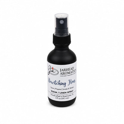 A 2 oz black spray bottle of Jarhead Aromatics Bewitching Hour Room & Linen Spray, showcasing an enchanting blend of exotic spices, dark florals, and smoky woods; the product is displayed against a white background.
