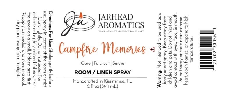 White label for Jarhead Aromatics Campfire Memories Room & Linen Spray | Maple, Clove & Smoky Embers, featuring directions, ingredients (maple, clove, smoky embers), warning, barcode, and company logo with a lit candle. Handcrafted in Kissimmee, FL. 2 fl oz spray for home fragrance and linens.