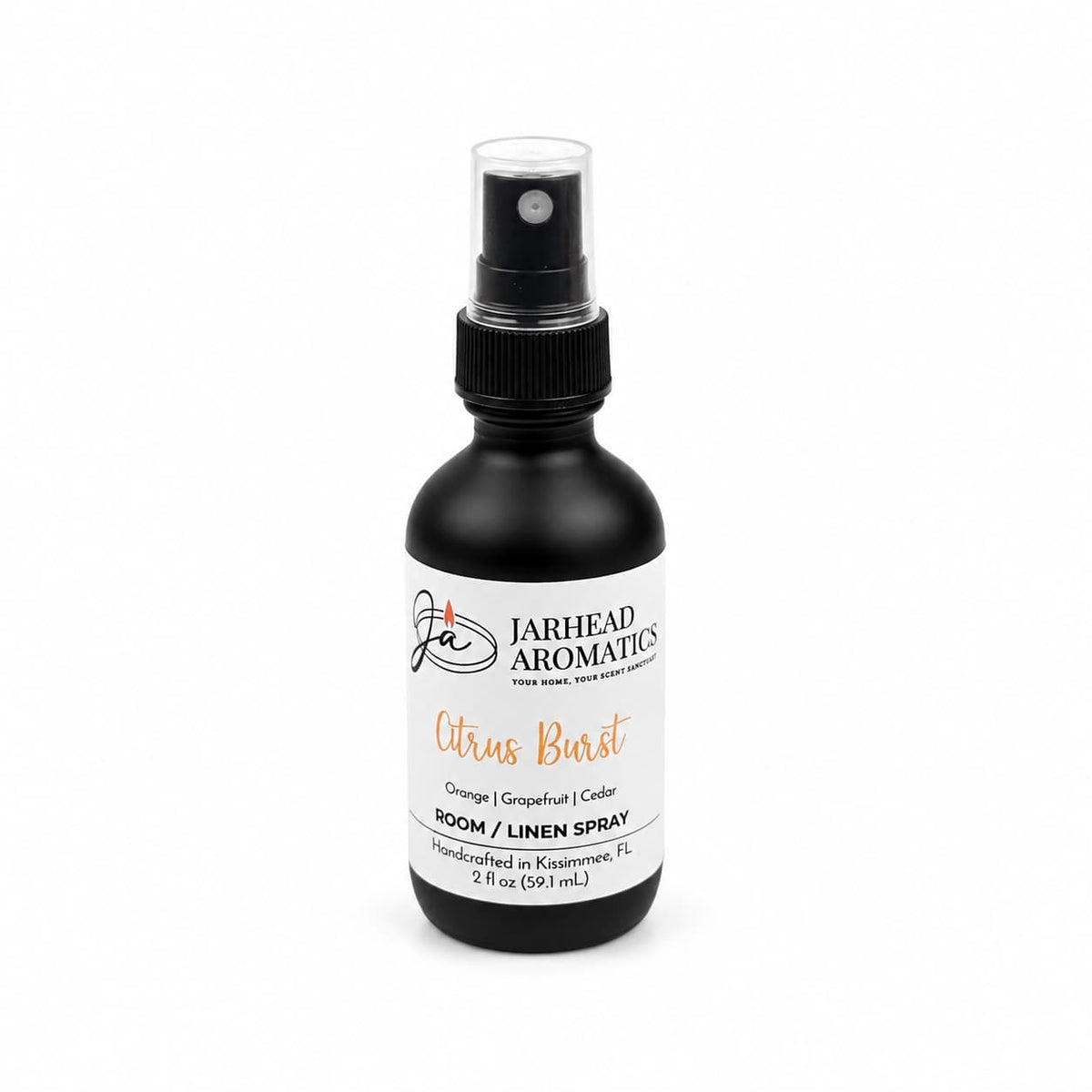 A black spray bottle labeled Jarhead Aromatics Citrus Burst Room & Linen Spray, featuring a refreshing blend of orange, mango, grapefruit, and peach for a vibrant home fragrance experience. The 2 oz bottle sports a white label with bold black and orange text, perfect for those who love an uplifting tropical fruit scent.