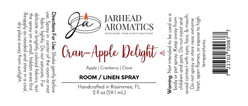 Label for Cran-Apple Delight Room & Linen Spray | Cranberry, Apple & Warm Cinnamon by Jarhead Aromatics. Immerse your space in a cozy blend of cranberry, apple, and warm cinnamon—an inviting fragrance any home will love. Ingredients: cranberry, apple, cinnamon. Directions: Shake well before use. Spray onto linens or into the air as desired. Warnings: For external use only; avoid contact with eyes—keep out of reach of children.