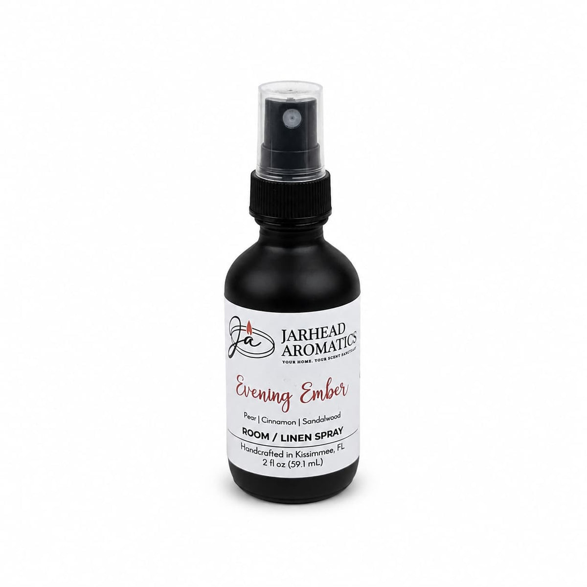 A black spray bottle labeled Jarhead Aromatics Evening Ember Room & Linen Spray, featuring a home fragrance profile with notes of plum, sandalwood, and soft smoke, 2 oz, set against a white background.