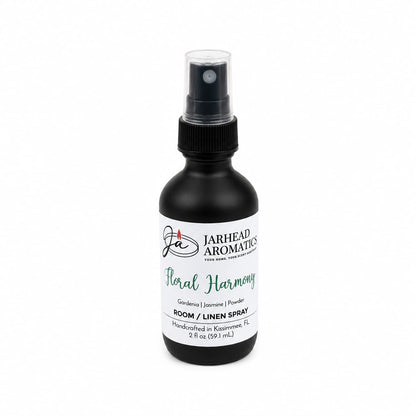 A black spray bottle labeled Jarhead Aromatics Floral Harmony Room & Linen Spray, this gardenia linen spray blends gardenia, jasmine, and tuberose fragrances for a refreshing home scent. Handcrafted in Kissimmee, FL, this floral room spray comes in a 2 fl oz (59.1 mL) size.
