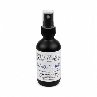 A black spray bottle labeled Jarhead Aromatics Galactic Twilight Room & Linen Spray delivers a luxurious home fragrance experience with notes of bergamot, amber, and sandalwood. The 2 fl oz bottle is handcrafted in Kissimmee, FL.