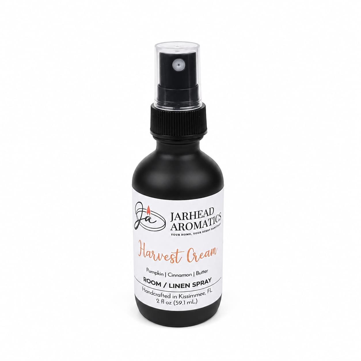 A black spray bottle labeled Jarhead Aromatics Harvest Cream Room & Linen Spray offers a luscious blend of pumpkin spice, brown sugar, and vanilla cream. Handcrafted in Kissimmee, FL, this gourmand home fragrance comes in a 2 fl oz size—perfect for refreshing any space—and is shown on a white background.